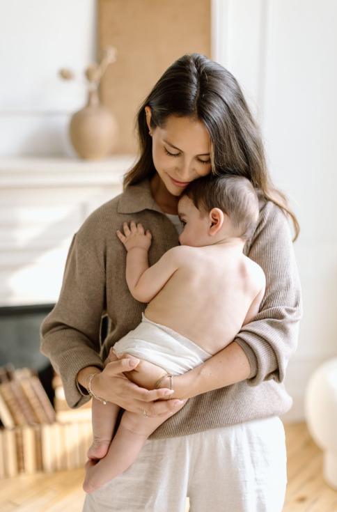 Brunette mom holding baby boy in her arms